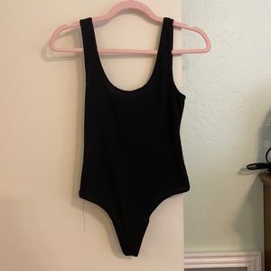 Black scoop neck bodysuit. Brand new. Never worn!